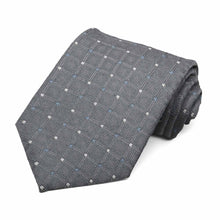 Load image into Gallery viewer, A dark gray necktie with tiny white and blue dots, rolled to show texture and pattern