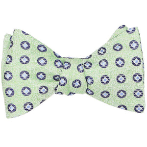 A tied green and blue medallion self-tie bow tie