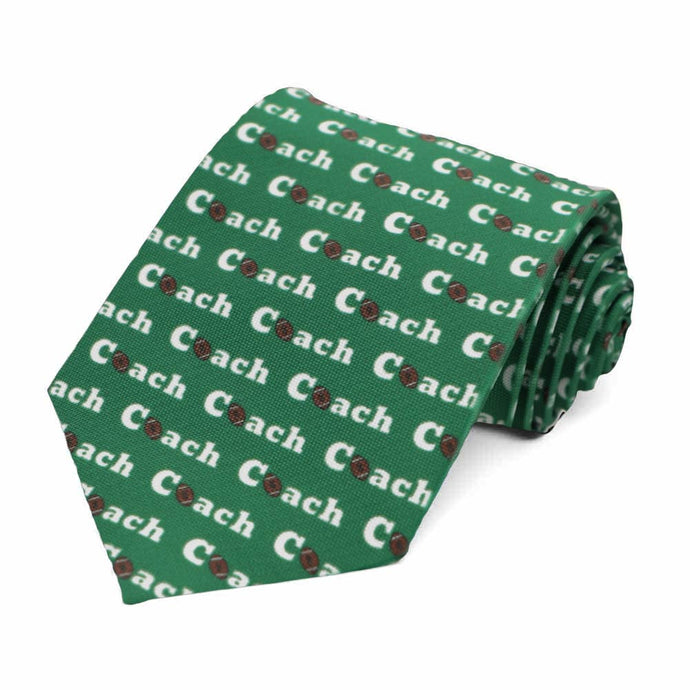 A green tie, rolled, with the words coach repeated with a football for the letter O