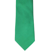 Load image into Gallery viewer, The front of a green herringbone tie, laid out flat