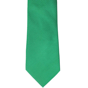 The front of a green herringbone tie, laid out flat