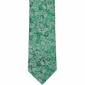 The front of a green, small floral pattern tie, laid out flat