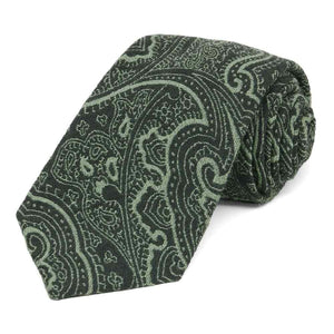 A dark green paisley necktie, rolled to show thick woven texture
