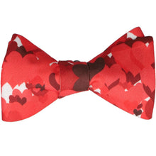 Load image into Gallery viewer, A tied self-tie bow tie with a scattered red heart design