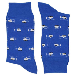 A pair of blue socks with a helicopter pattern, folded to show off design