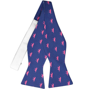 An untied hot pink and dark blue horse-themed self-tie bow tie with an all white collar