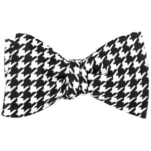 A tie black and white houndstooth self-tie bow tie