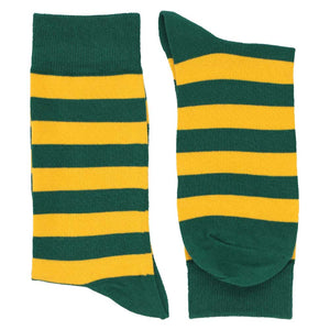 A folded pair of men's hunter green and golden yellow striped crew socks