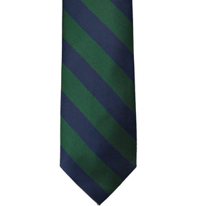 The front of a hunter green and navy blue striped tie