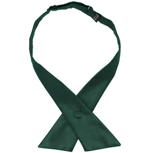 A hunter green crossover tie, snapped with flat front ends