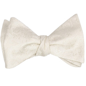 A tied self tie bow tie in an ivory tone-on-tone floral pattern