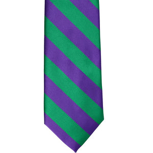 The front of a kelly green and purple striped tie, laid out flat