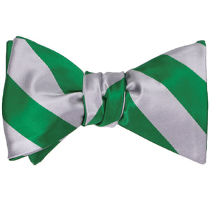 A tied self-tie bow tie in Kelly green and silver stripes
