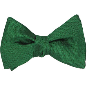 A kelly green self-tie bow tie, tied