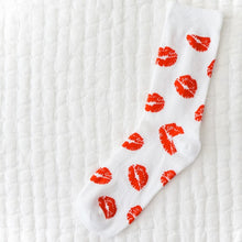 Load image into Gallery viewer, A single white sock covered in a red lipstick kiss pattern