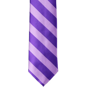 The front of a lavender and purple striped tie in a narrowed width, laid flat