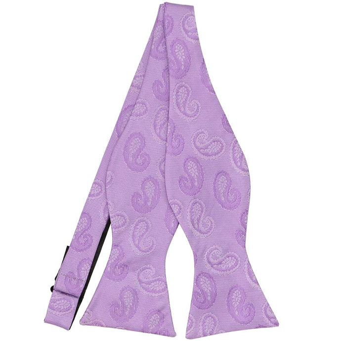 A lavender paisley bow tie, untied, in a tone-on-tone pattern