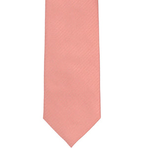 The front of a light coral herringbone tie, laid out flat