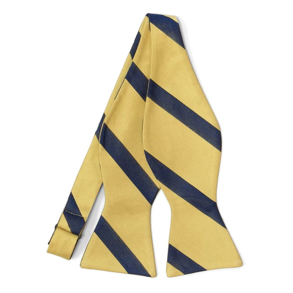 An untied light gold and navy blue striped self-tie bow tie