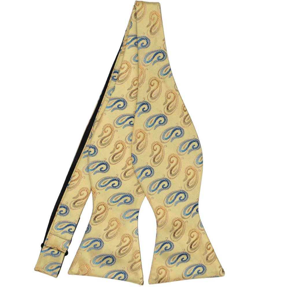 A light gold and blue paisley self-tie bow tie, untied