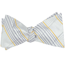Load image into Gallery viewer, A light gray plaid self-tie bow tie, tied