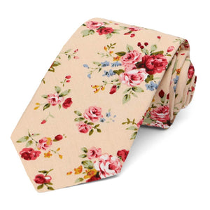 The front of a peach floral tie, rolled to show off the tie tip