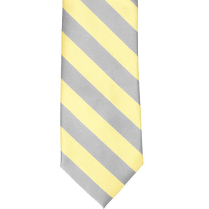 The front of a light yellow and silver striped tie