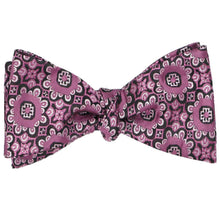 Load image into Gallery viewer, A tied self-tie bow tie in a deep magenta floral pattern