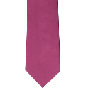 The front of a magenta herringbone tie, laid out flat