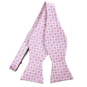 An untied light pink self-tie bow tie with a white trellis pattern