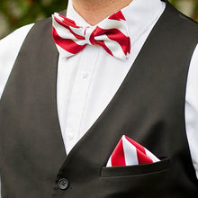 Load image into Gallery viewer, Man wearing a red and white striped bow tie, pocket square and black vest