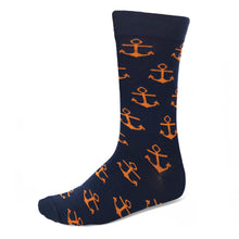 Load image into Gallery viewer, A navy blue sock with orange boat anchors