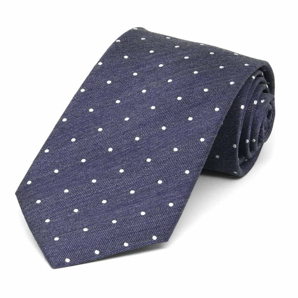 Denim tie with tiny white dots, rolled to show fabric texture