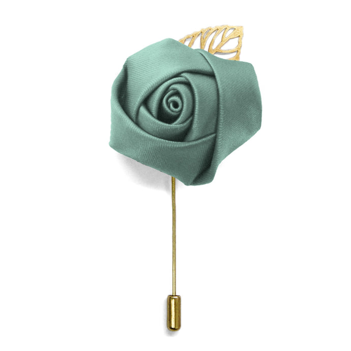 A flower lapel pin with a eucalyptus puff, gold pin and gold leaf