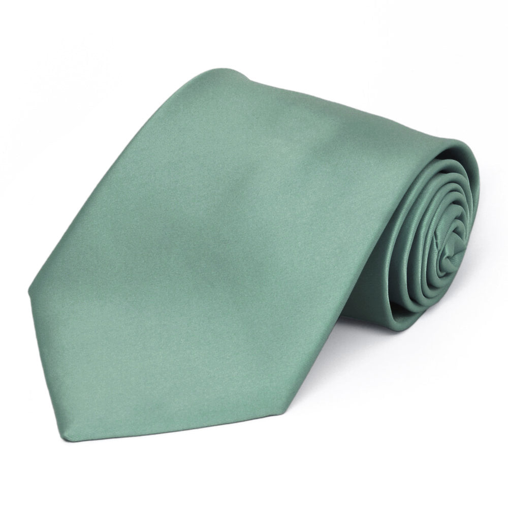 A eucalyptus green solid tie, rolled to show off the color