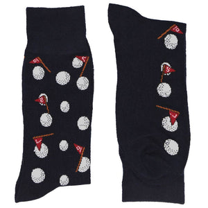 A folded navy pair of men's socks with a novelty golf ball and flag design