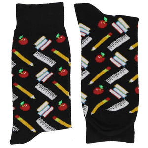 Pair of folded men's black socks with scattered school supplies