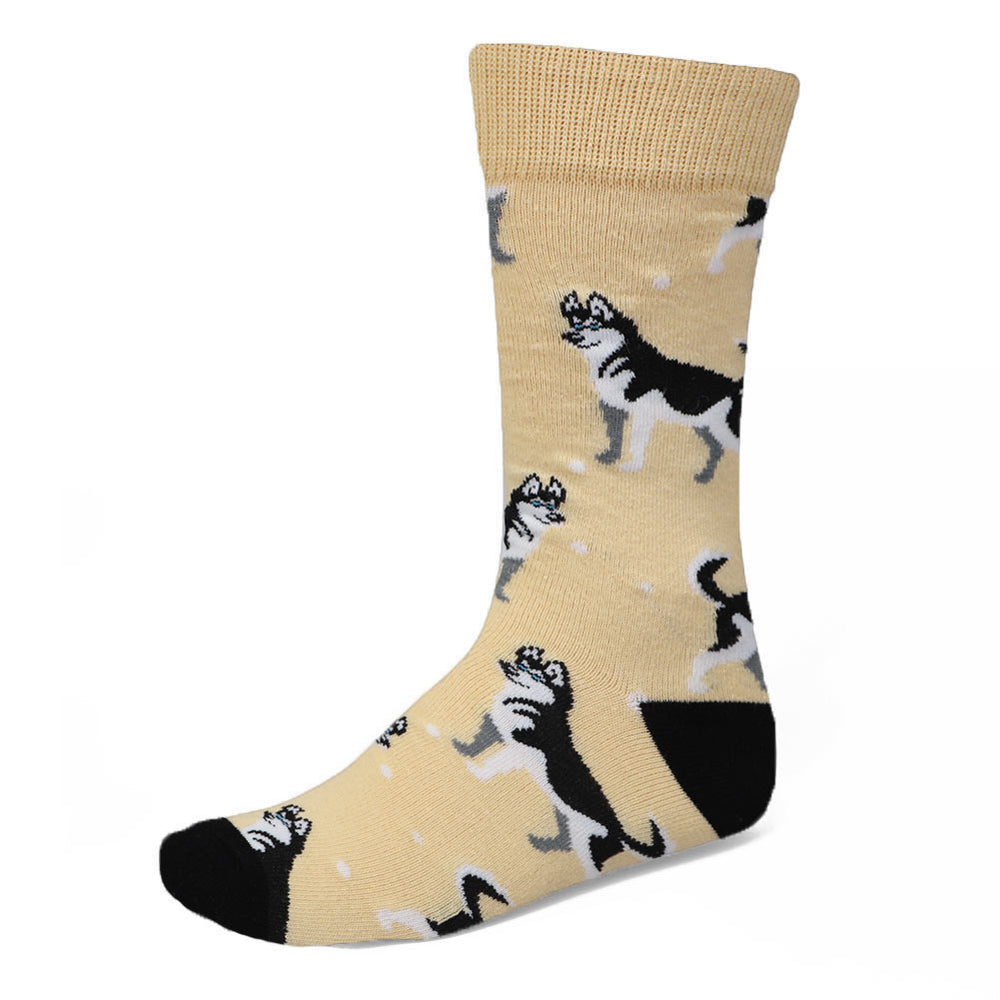 Black and white siberian husky socks on a tan background