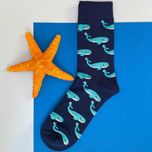 Load image into Gallery viewer, A whale sock, laid out flat next to a star fish