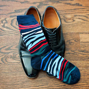 Pair of men's colorful zebra pattern socks with black dress shoes
