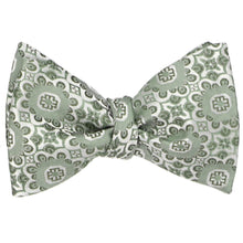 Load image into Gallery viewer, A tied self-tie bow tie in a mint green abstract floral pattern