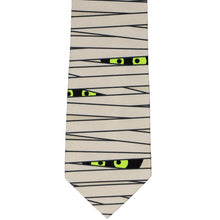Load image into Gallery viewer, Front view of a mummy wrapped necktie with spooky glowing eyes