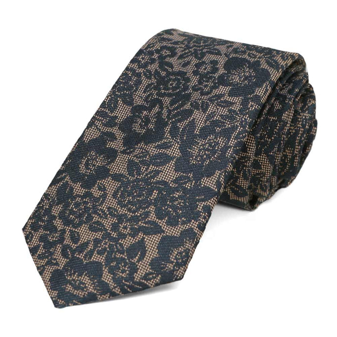Navy blue and tan floral tie, rolled to show the rich woven texture