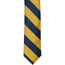 Load image into Gallery viewer, The front of a navy blue and gold striped tie, laid out flat