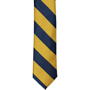 The front of a navy blue and gold striped tie, laid out flat