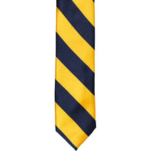 Load image into Gallery viewer, The front of a navy blue and golden yellow striped tie, laid out flat