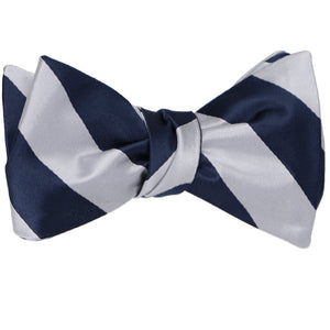 Navy blue and silver striped self-tie bow tie, tied