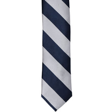 Load image into Gallery viewer, The front of a navy blue and silver striped skinny tie, laid out flat