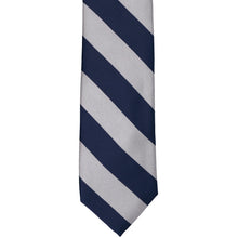 Load image into Gallery viewer, The front of a navy blue and silver striped tie, laid out flat