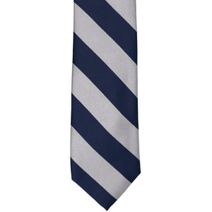 The front of a navy blue and silver striped tie, laid out flat